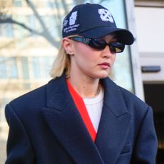 Gigi Hadid wears a baseball cap and blazer coat while running errands