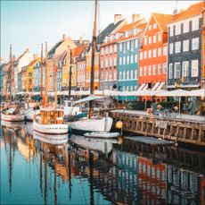 Moored boats along a narrow canal in Copenhagen old town, Denmark