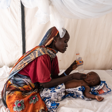 Nadifa Mohamed Adam, 22, gives water to his child who is suffering from fever and malnutrition at the malaria department tent in the Doctors Without Borders clinic inside the Adre camp, where around 200,000 people are currently taking refuge on September 19, 2023 in Adre, Chad. The conflict in Sudan, entering its sixth month, has left thousands of civilians dead and displaced more than five million people. More than 420,000 people have already found refuge in neighbouring Chad as hundreds continue to arrive daily. 